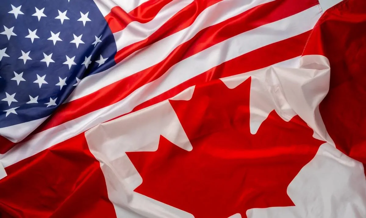 flags-of-canada-and-usa-folded-together flags-of-canada-and-usa-folded-together
